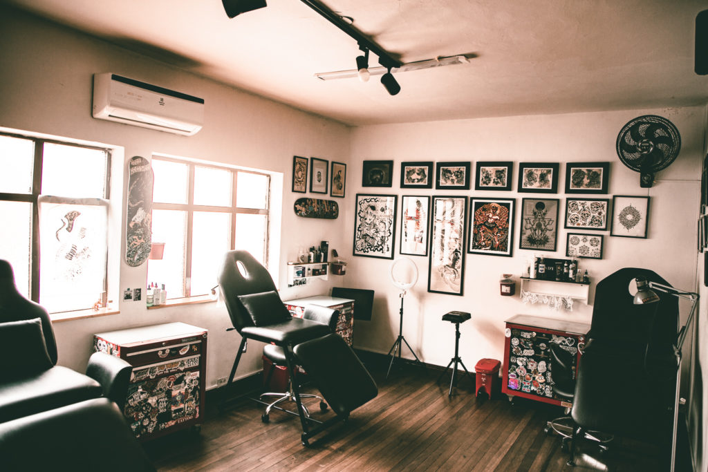 tattoo room with designs on the walls