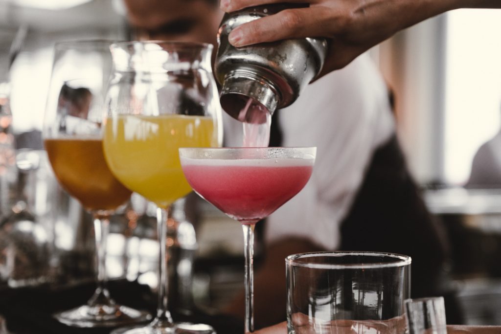 Man pouring colorful cocktails
