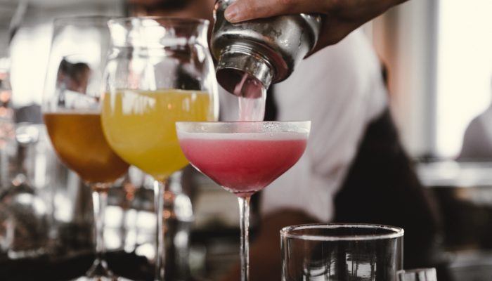 Man pouring colorful cocktails